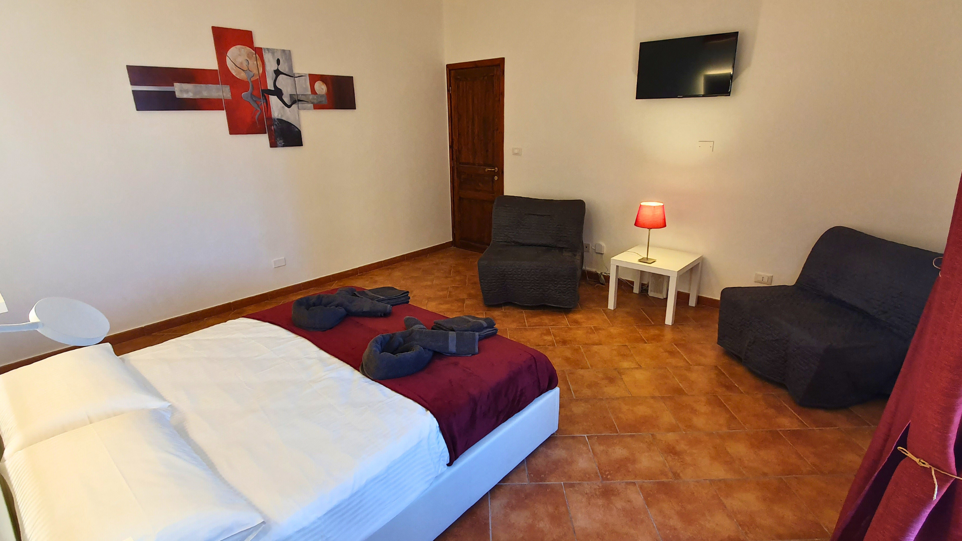 vista-prima-camera-con-letto-matrimoniale-e-due-poltrone